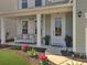 Beautiful covered front porch with swing, landscaping, and elegant exterior at 2889 Backman St, Mount Pleasant, SC 29466