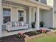 Inviting covered front porch with swing and decorative landscaping for a charming curb appeal at 2889 Backman St, Mount Pleasant, SC 29466