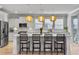 Bright kitchen with an island, modern pendant lights, and white cabinets at 2889 Backman St, Mount Pleasant, SC 29466