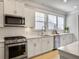 Bright kitchen with white cabinets, stainless steel appliances, and a modern backsplash at 2889 Backman St, Mount Pleasant, SC 29466