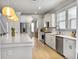 Bright kitchen features white cabinets, stainless appliances, and a large quartz countertop island at 2889 Backman St, Mount Pleasant, SC 29466