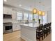 Modern kitchen with a large island, pendant lights, and stainless steel appliances at 2889 Backman St, Mount Pleasant, SC 29466