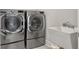Modern laundry room featuring LG washer and dryer, ceramic tile and a large utility sink at 2889 Backman St, Mount Pleasant, SC 29466