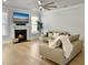Comfortable living room featuring a fireplace, TV, large windows, and hardwood flooring at 2889 Backman St, Mount Pleasant, SC 29466