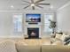 Comfortable living room featuring a fireplace, TV, large windows, and hardwood flooring at 2889 Backman St, Mount Pleasant, SC 29466