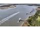 Scenic aerial view of a river with boat docks and a boat leaving a wake at 2906 Quarterdeck Ct, Mount Pleasant, SC 29466