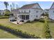 Aerial view of the backyard featuring an outdoor kitchen, fire pit, screened-in porch, and green lawn at 2906 Quarterdeck Ct, Mount Pleasant, SC 29466