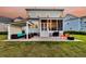 Expansive backyard with patio, fire pit, outdoor kitchen, screened porch, and lush lawn at 2906 Quarterdeck Ct, Mount Pleasant, SC 29466