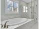 Luxurious bathroom featuring a soaking tub and glass-enclosed shower with elegant marble accents at 2906 Quarterdeck Ct, Mount Pleasant, SC 29466