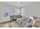 Cozy bedroom with wood floors, neutral walls, and a sunny window at 2906 Quarterdeck Ct, Mount Pleasant, SC 29466