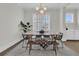 A modern dining room featuring a decorative chandelier, minimalist furniture, and natural lighting at 2906 Quarterdeck Ct, Mount Pleasant, SC 29466