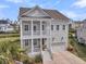 Charming two-story home with double porches, stately columns, and a two-car garage, perfect for coastal living at 2906 Quarterdeck Ct, Mount Pleasant, SC 29466