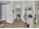 Elegant foyer with hardwood floors, stylish console table, a decorative mirror, and a view of the living spaces at 2906 Quarterdeck Ct, Mount Pleasant, SC 29466