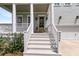 Welcoming front porch with white railings and columns, leading to a stylish front door and a two-car garage at 2906 Quarterdeck Ct, Mount Pleasant, SC 29466