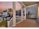 Exterior view from the porch showcasing columns, railings, and charming neighborhood homes under a colorful sunset at 2906 Quarterdeck Ct, Mount Pleasant, SC 29466