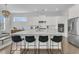 Modern kitchen with white cabinets, a large island with seating, stainless steel appliances, and ample counter space at 2906 Quarterdeck Ct, Mount Pleasant, SC 29466