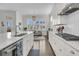 Open concept kitchen featuring stainless appliances, white cabinets, hardwood floors, and modern finishes at 2906 Quarterdeck Ct, Mount Pleasant, SC 29466