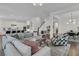 Spacious open-concept living area with sofas, armchairs, a view of the kitchen, and hardwood floors at 2906 Quarterdeck Ct, Mount Pleasant, SC 29466