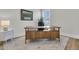 Bright office with a wooden desk, neutral walls, and a window for natural light at 2906 Quarterdeck Ct, Mount Pleasant, SC 29466