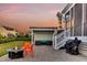 Covered outdoor living area with fire pit, outdoor kitchen, seating, and screened-in porch access at 2906 Quarterdeck Ct, Mount Pleasant, SC 29466