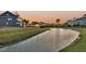 Scenic view of a tranquil pond surrounded by well-maintained homes and landscaping at 2906 Quarterdeck Ct, Mount Pleasant, SC 29466