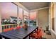 Enjoyable screened porch with dining table and chairs overlooking neighboring homes at 2906 Quarterdeck Ct, Mount Pleasant, SC 29466