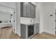 Wet bar featuring gray cabinets, sink, and a beverage cooler, next to a bedroom at 2906 Quarterdeck Ct, Mount Pleasant, SC 29466