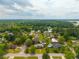 An aerial view captures the neighborhood, showcasing the home's location among lush trees and other residences at 310 Land O Pines Cir, Moncks Corner, SC 29461