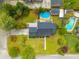 This aerial view features the home, manicured yard, above-ground pool, and surrounding greenery at 310 Land O Pines Cir, Moncks Corner, SC 29461