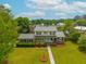An aerial view of the home displays the beautifully maintained yard and complemented by the light blue front door at 310 Land O Pines Cir, Moncks Corner, SC 29461