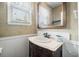 Charming bathroom featuring a wood vanity, marble countertop, and decorative mirror at 310 Land O Pines Cir, Moncks Corner, SC 29461