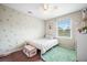 Light-filled bedroom with leaf-patterned walls and a twin bed, perfect for a  at 310 Land O Pines Cir, Moncks Corner, SC 29461