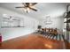 Open-concept dining area features a rustic table, shiplap accents, and hardwood floors for a cozy feel at 310 Land O Pines Cir, Moncks Corner, SC 29461