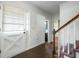 Bright entryway features brick floor, classic staircase, and a white front door with glass accents at 310 Land O Pines Cir, Moncks Corner, SC 29461