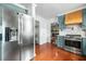 Stylish kitchen featuring stainless steel appliances, light-colored shaker cabinets, and hardwood flooring at 310 Land O Pines Cir, Moncks Corner, SC 29461