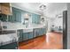 Charming kitchen boasts sleek appliances, shaker cabinets, and a farmhouse sink with lots of natural light at 310 Land O Pines Cir, Moncks Corner, SC 29461