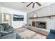 Cozy living room with brick fireplace and mantel, offering comfortable seating, and a ceiling fan at 310 Land O Pines Cir, Moncks Corner, SC 29461