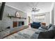 Charming living room features brick fireplace, plush seating, and bright natural light throughout at 310 Land O Pines Cir, Moncks Corner, SC 29461