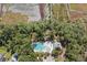 Aerial view of community pool, surrounded by dense trees and marshy land, offering a serene and private setting at 3133 Cold Harbor Way, Charleston, SC 29414