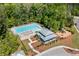 Aerial view of the community amenities showcasing the pool, playground, and clubhouse surrounded by mature trees and landscaping at 3133 Cold Harbor Way, Charleston, SC 29414