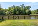 Picturesque backyard featuring lush greenery, a serene pond view, and a wooden fence, providing privacy at 3133 Cold Harbor Way, Charleston, SC 29414