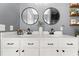 Bathroom featuring a double sink vanity with modern hardware and round mirrors at 3133 Cold Harbor Way, Charleston, SC 29414