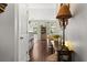 Warm entryway featuring hardwood floors, a decorative table with lamps, and an open view into the living spaces at 3133 Cold Harbor Way, Charleston, SC 29414