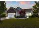 Charming single-Gathering home with brick and siding, showcasing a well-manicured lawn and attached two-car garage at 3133 Cold Harbor Way, Charleston, SC 29414