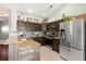 Stylish kitchen with granite countertops, stainless steel appliances, dark cabinetry, and rustic wood accents at 3133 Cold Harbor Way, Charleston, SC 29414