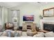 Relaxing living room with a fireplace, stylish decor, and large windows providing natural light at 3133 Cold Harbor Way, Charleston, SC 29414