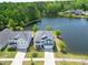 Aerial shot of blue two-story home by the lake with nice landscaping, sidewalk and driveway on a sunny day at 3149 Timberline Dr, Johns Island, SC 29455