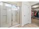 Modern bathroom with a glass-enclosed shower and neutral tones, adjoining a walk-in closet at 3149 Timberline Dr, Johns Island, SC 29455