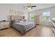 Well-lit bedroom with modern fan, hardwood floors, and a tufted headboard at 3149 Timberline Dr, Johns Island, SC 29455