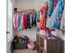 Well-organized closet with hanging clothes, shelves, and storage containers at 3149 Timberline Dr, Johns Island, SC 29455